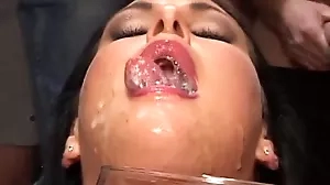 A stunning brunette gets covered in cum in this video